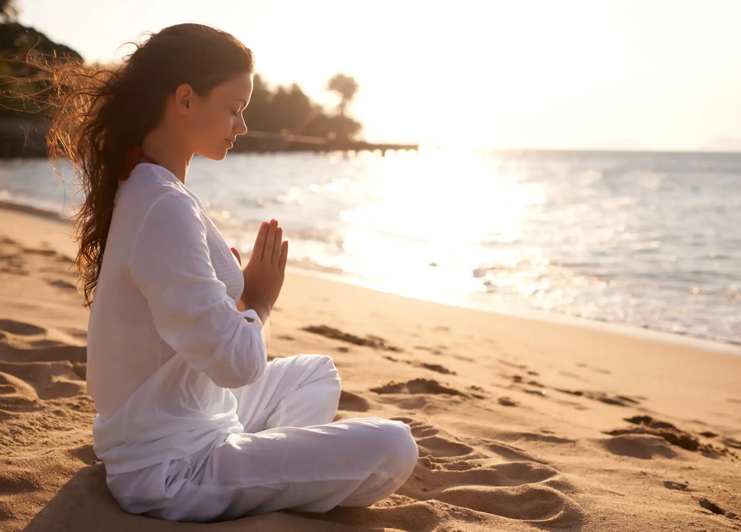 woman meditating beach